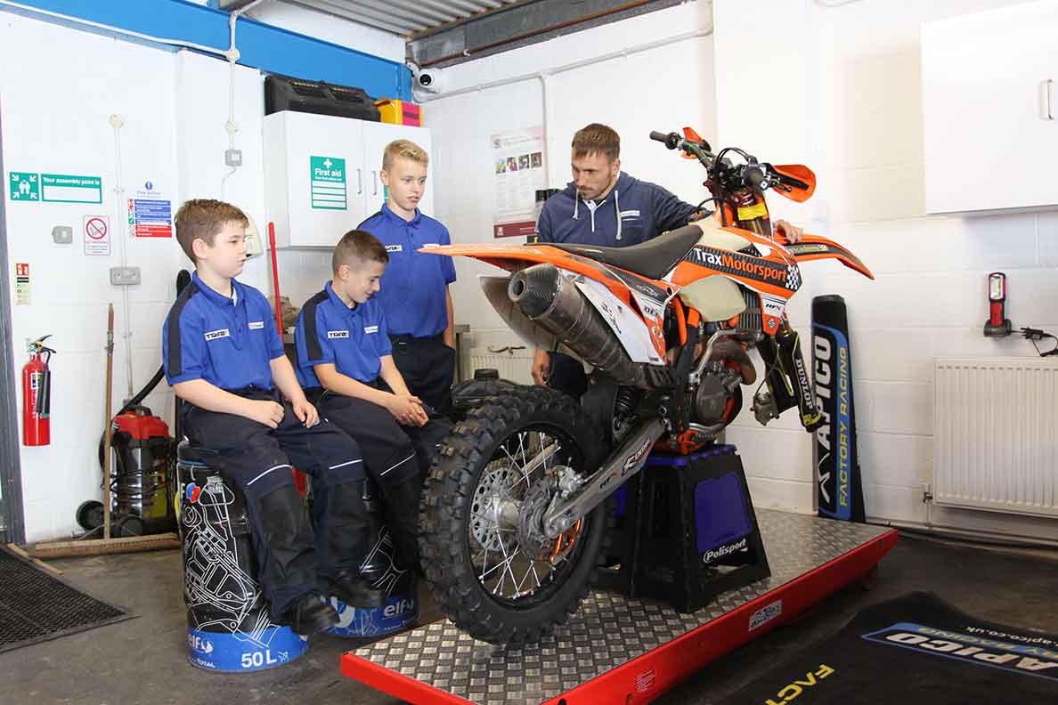 Group of students around a motorcross bike